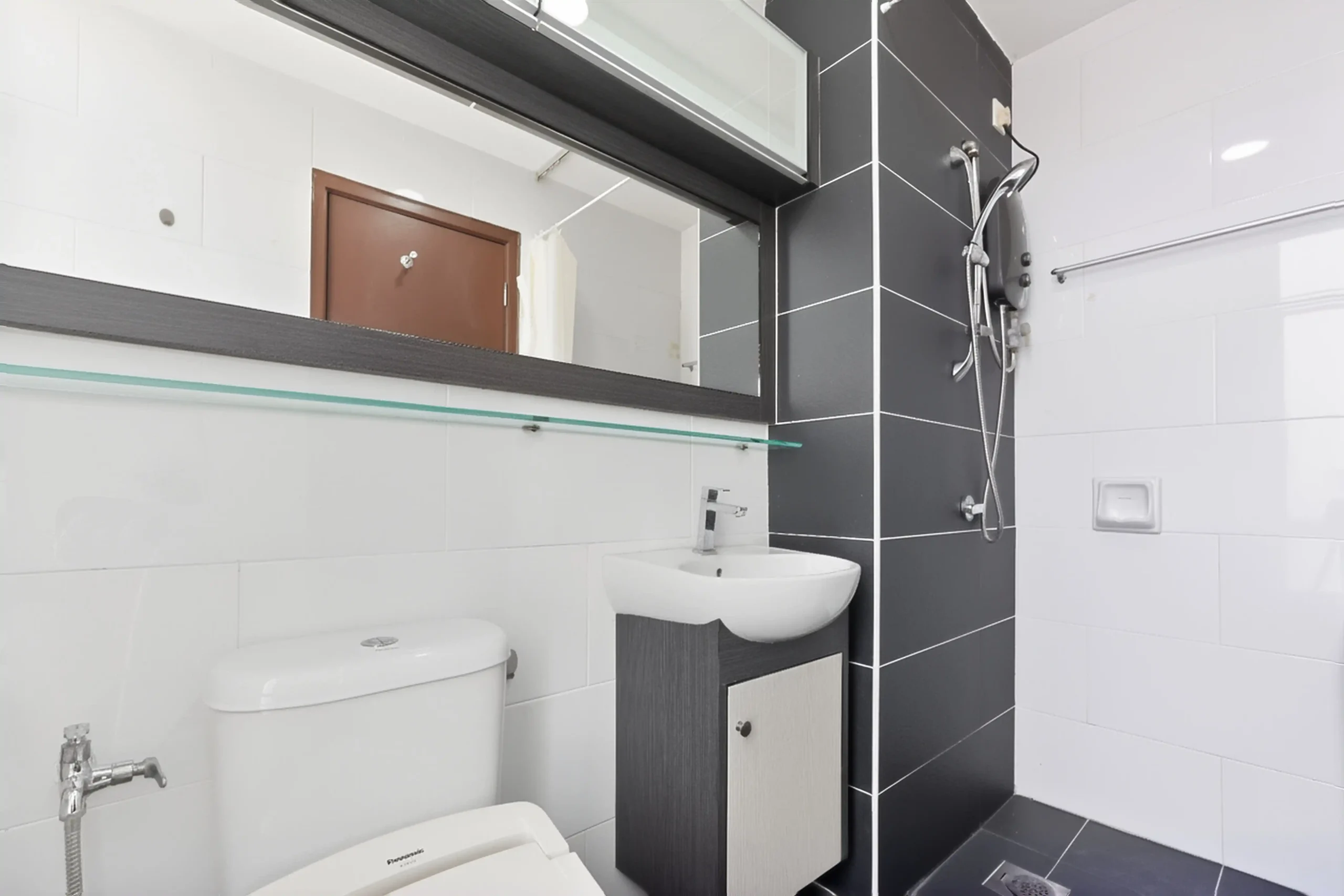 Well-maintained second bathroom with toilet and shower for apartment guests
