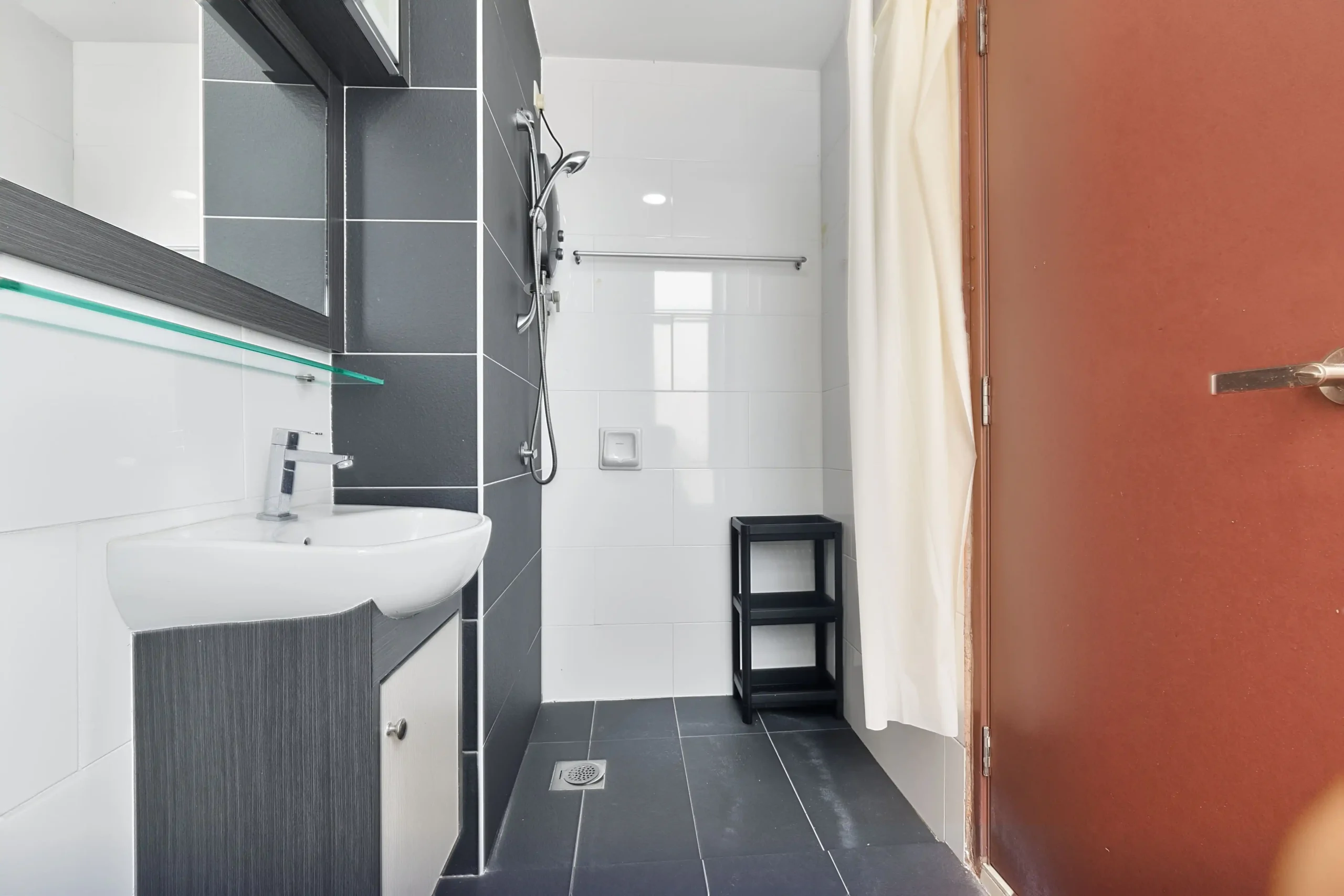 Well-maintained second bathroom with toilet and shower for apartment guests