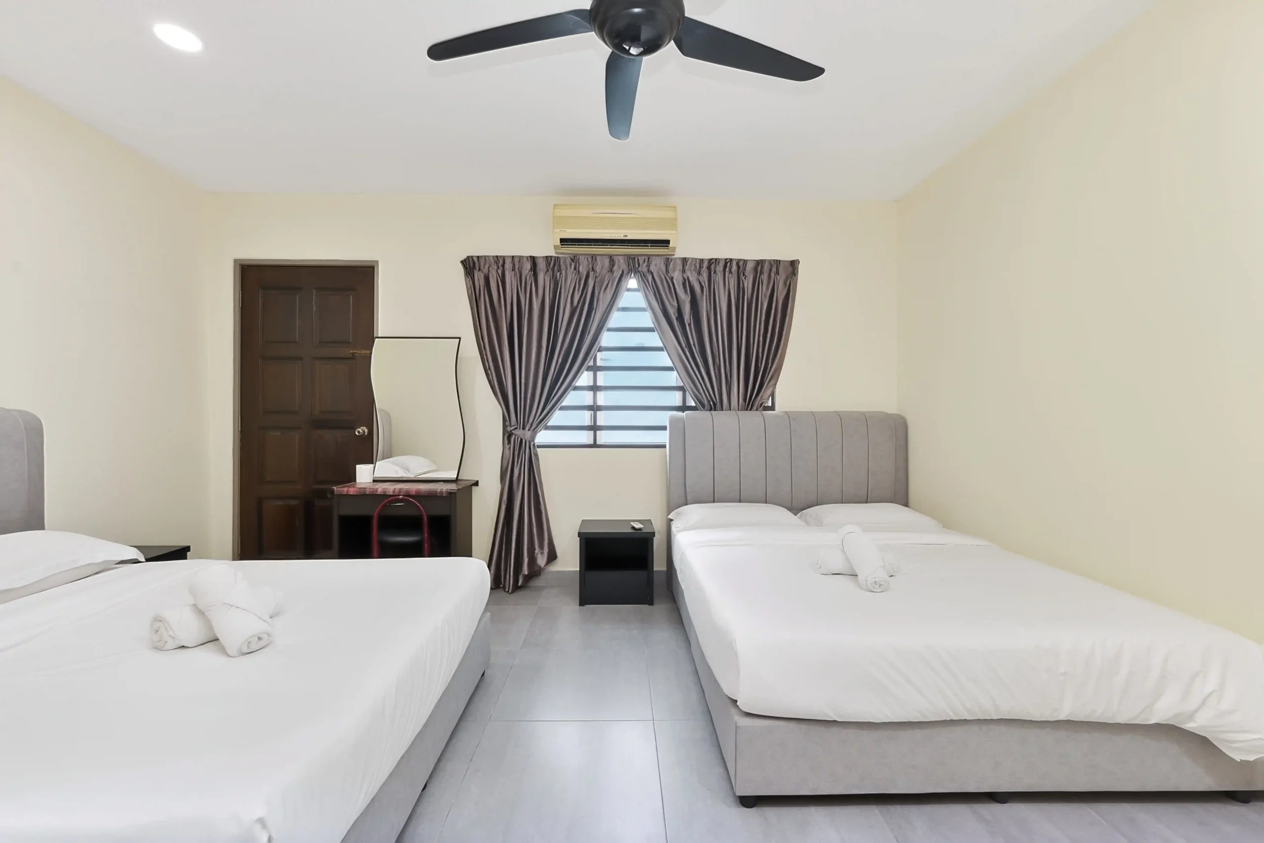 Bedroom 1 setup with 1 Queen bed and 1 Single bed with air-conditioning