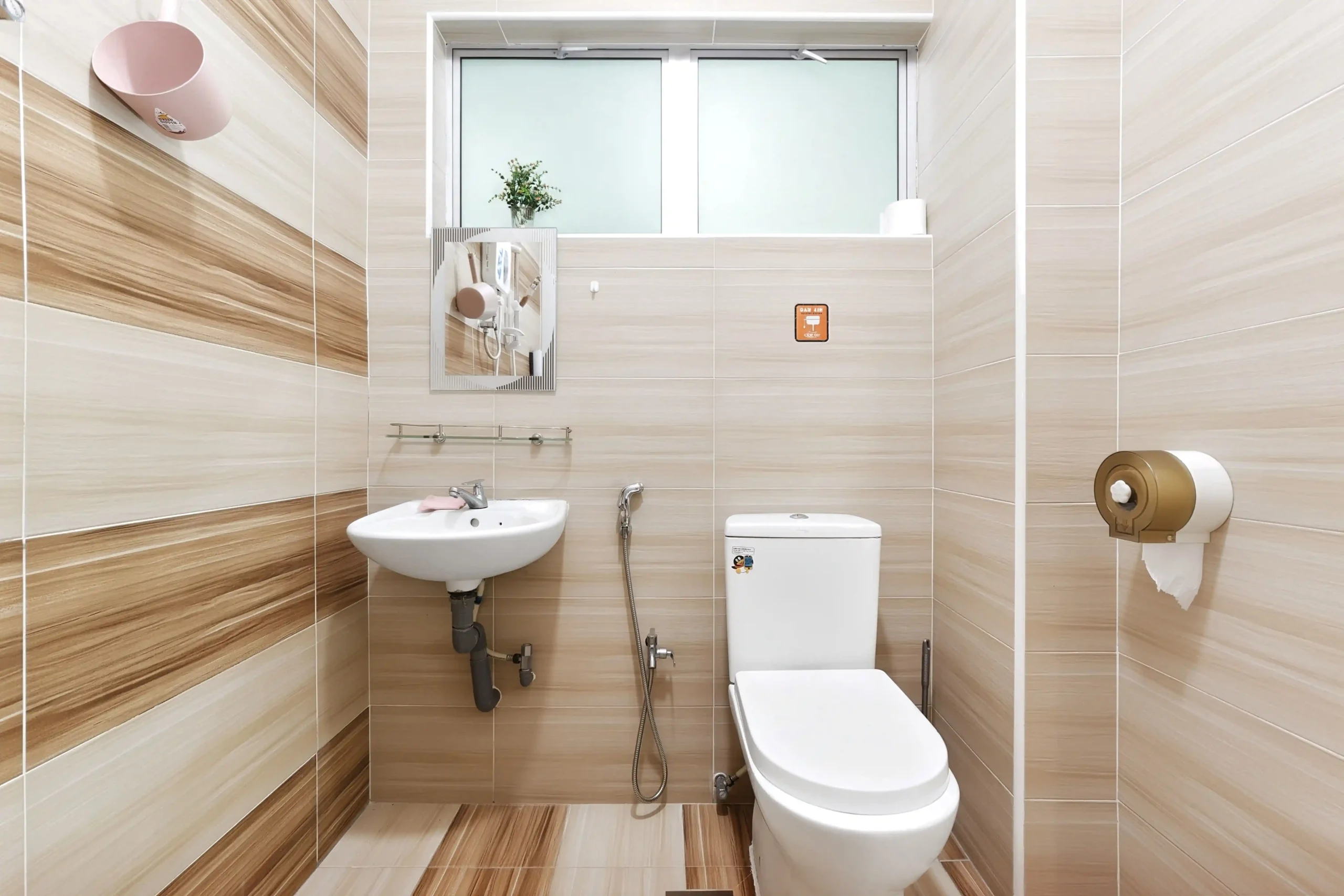Clean combined shower and toilet bathroom with hot water in Ipoh homestay