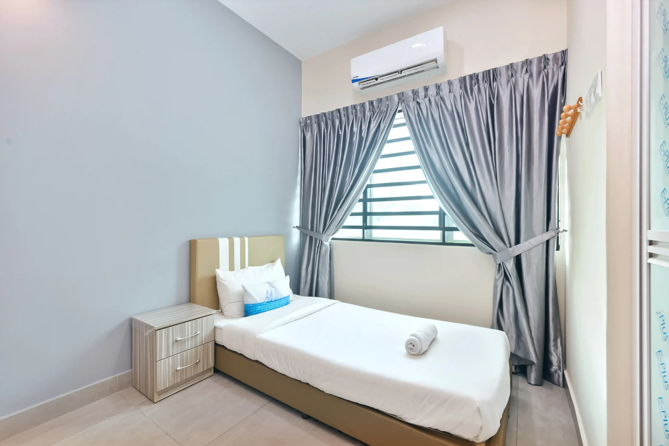 Bedroom 1 setup with 1 Queen bed and 1 Single bed with air-conditioning