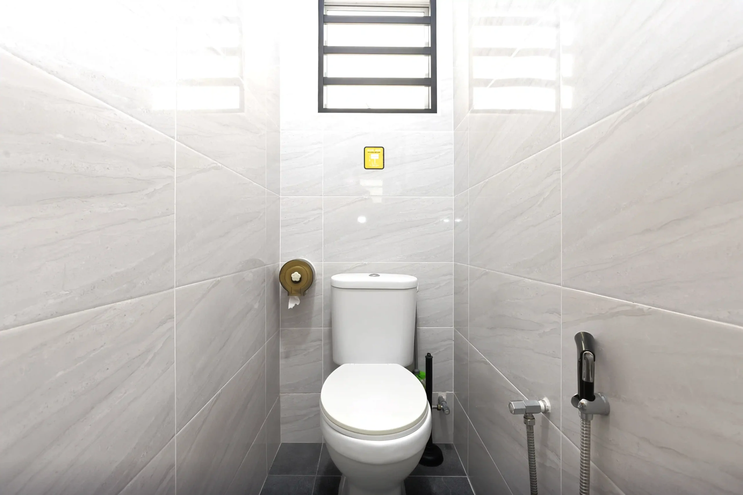 Clean combined shower and toilet bathroom with hot water in Ipoh homestay